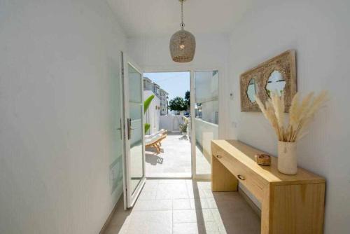 a room with a hallway with a table and a mirror at Casa Marinero beach 2 in Torrox Costa