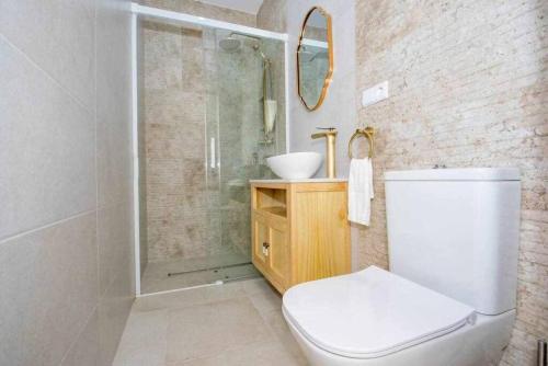 a bathroom with a shower and a toilet and a sink at Casa Marinero beach 2 in Torrox Costa