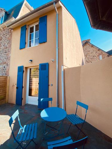 a patio with a table and chairs in front of a house at Kerannette - Spa - Plage et centre ville in Perros-Guirec