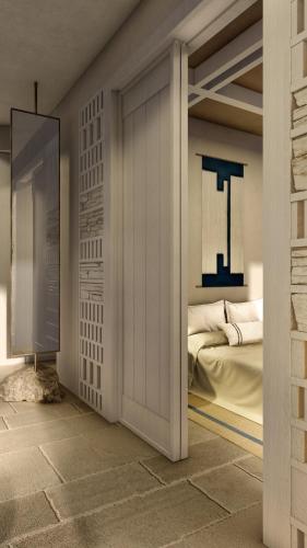 a bedroom with a door leading to a bed at Atlantis Hotel in Naousa