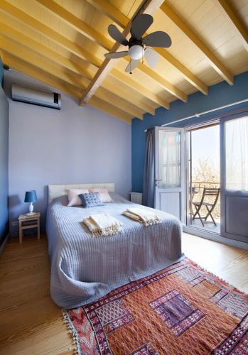 a bedroom with a bed and a ceiling fan at Enjoy Golden Horn views from Tangerine house in Istanbul