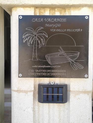 a sign for a restaurant with a palm tree at Casa MaryGiò in San Pietro in Bevagna