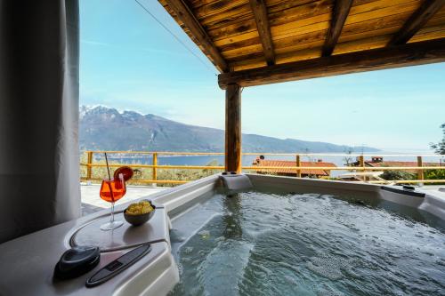 a hot tub with a view of the water at Residence Erika in Tignale
