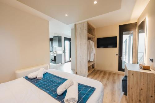 a bedroom with a bed with towels on it at Grand Kourouta Pool Apartments in Kourouta