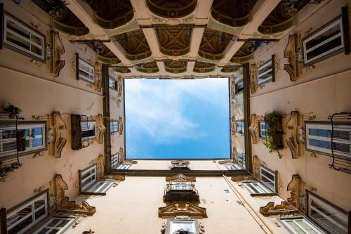 a view from the inside of a building with a large window at It's Room Naples in Naples