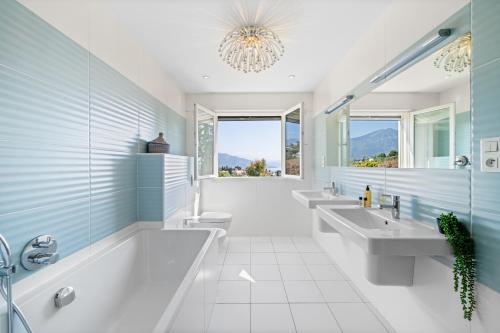 a bathroom with two sinks and two toilets at Villa Shangrila, charming house with sea view, swimming pool and garden nr Monaco and Italy in Roquebrune-Cap-Martin