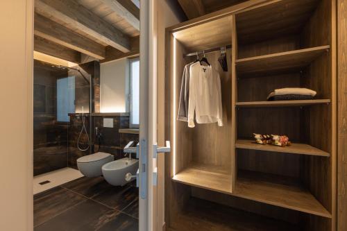 a bathroom with a walk in shower and a toilet at Lillaz Home - Apartments in Cogne