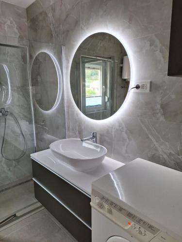 a bathroom with a sink and a mirror at Zara apartma in Podstrana