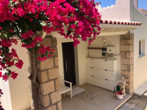 a room with pink flowers hanging from a building at Villa Daria Kamares Tala Luxury Sea View in Paphos