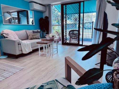 a living room with a couch and a table at The Love Shack in Bongaree