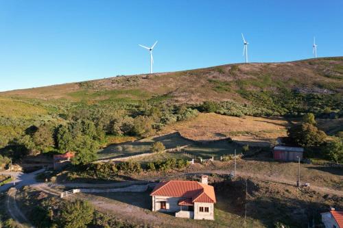a house on the side of a hill at Casa Florestal, na Branda da Bouça dos Homens in Gavieira