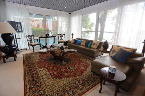 a living room with a couch and a rug at Nayara Villa Desa Budo in Wori