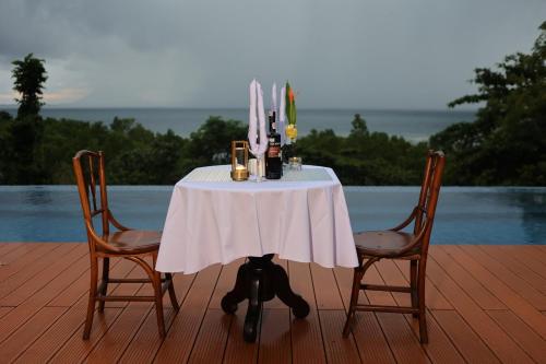 a table with a white table cloth and two chairs at Nayara Villa Desa Budo in Wori