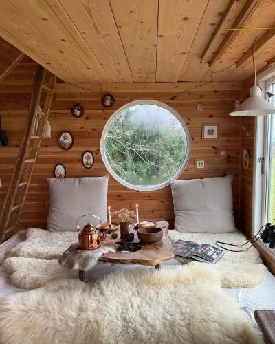 a room with a bed with a table and a window at Treehouse escape in Kværndrup