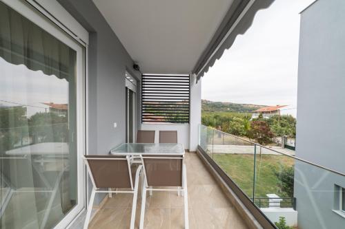 a balcony with a table and a view at Roxani Residential Complex in Ofrínion