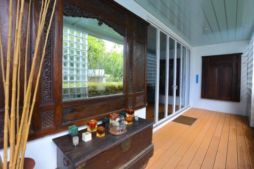 a room with a large window and a wooden floor at Nayara Villa Desa Budo in Wori