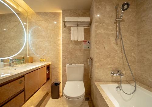 a bathroom with a toilet and a shower and a sink at Hotel Golden Dragon in Macau
