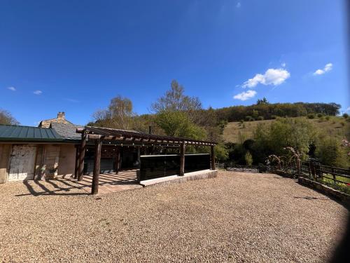 a building with a pavilion in front of a house at Tanyard Barn - Luxury Hot Tub & Secure Dog Field Included in Old Glossop