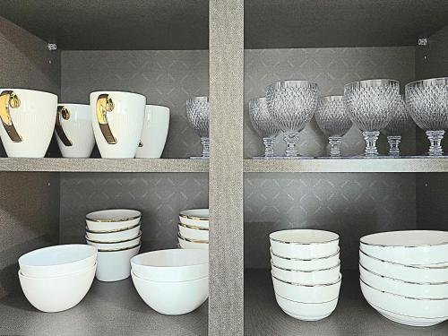 two pictures of plates and bowls on a shelf at 머물다 울산 울산공항 5분 태화강역10분 울산 병영성 in Ulsan