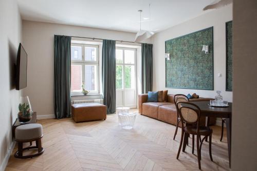 a living room with a couch and a table at Browar Hevelius Apartments by Grand Apartments in Gdańsk