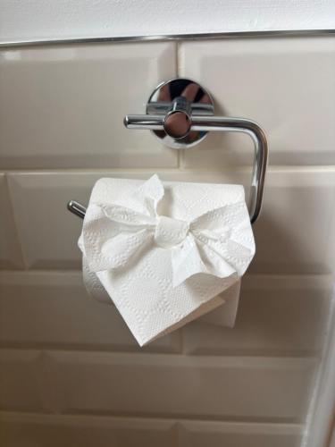 a roll of toilet paper with a bow on a holder at Idyllic, 5 Star Family Home with Panoramic Views, Kinvara on the Wild Atlantic Way in Kinvara