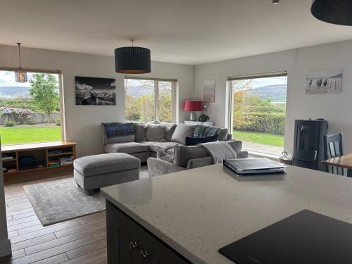 a living room with a couch and a table at Idyllic, 5 Star Family Home with Panoramic Views, Kinvara on the Wild Atlantic Way in Kinvara