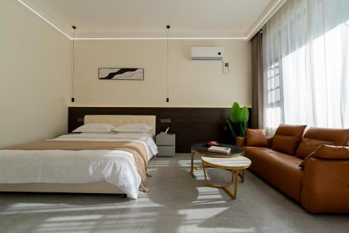 a bedroom with a bed and a couch at Wuyi Whispering Maple in Dali