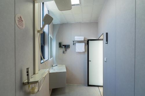 a bathroom with a sink and a mirror at Wuyi Whispering Maple in Dali