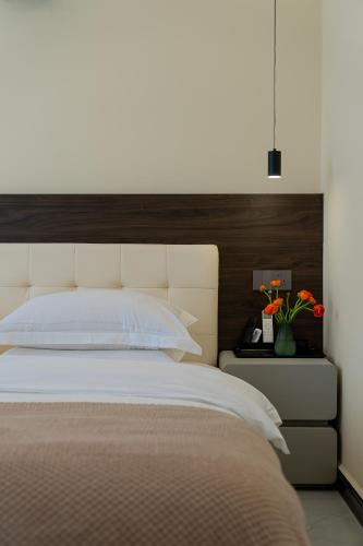 a bedroom with a large bed with a wooden headboard at Wuyi Whispering Maple in Dali