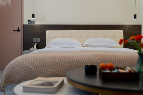 a bedroom with a large bed and a table with a tray of oranges at Wuyi Whispering Maple in Dali