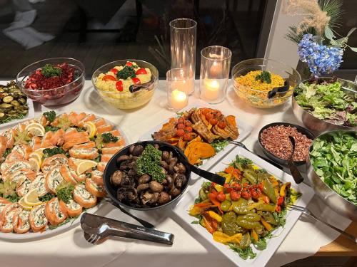 a table with many different types of food on it at Hotel Pflugsmühle in Abenberg