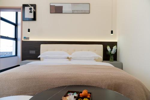 a bedroom with a large bed with a tray on it at Wuyi Whispering Maple in Dali