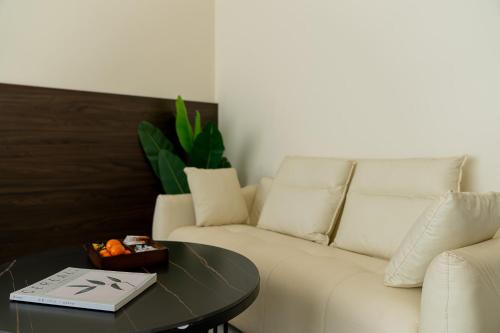 a living room with a white couch and a table at Wuyi Whispering Maple in Dali