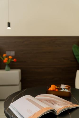 an open book sitting on a table with a book at Wuyi Whispering Maple in Dali