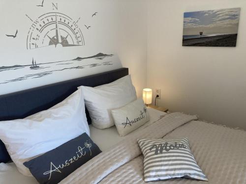 a bedroom with two beds with white pillows at Berolina 125 - Sonnenseite in Dahme