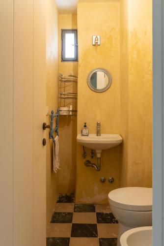 a bathroom with a sink and a toilet at La Casa nel Borgo - Artemisia Homes in Nociglia