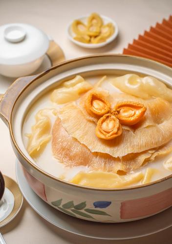 a bowl of soup with a monkey face on it at Hotel Golden Dragon in Macau