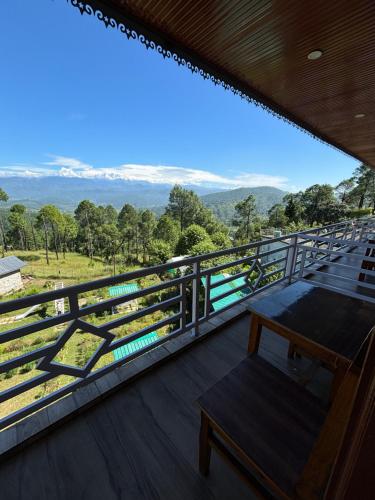 a balcony with a view of the mountains at Lap Of Himalayas Resort in Kausani