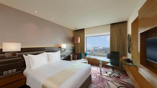 a hotel room with a bed and a television at Holiday Inn Jaipur City Centre by IHG in Jaipur