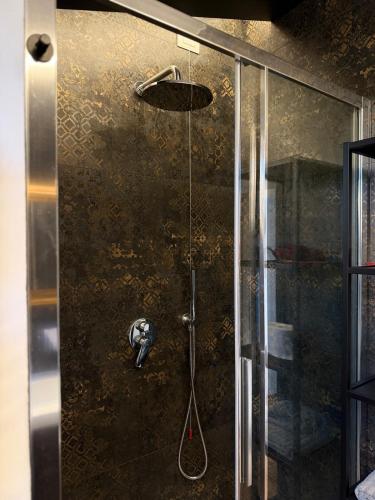 a shower with a shower head and a glass door at Explore Perugia from this Top Location in Perugia