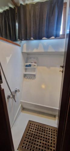 an open door of an rv with a shelf and scissors at Salvador BAHIA Boat and Breakfast in Lido di Ostia