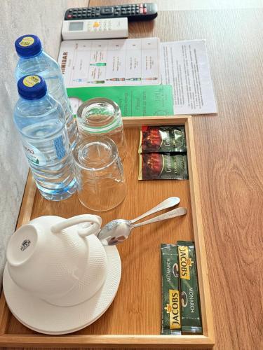 a table with a tea pot and a bottle of water at Boutique Hotel Tiflis in Tbilisi City