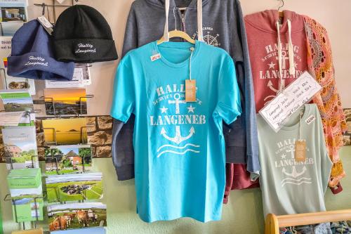 a group of shirts hanging on a wall at Wohnung Hallighof in Honkenswarft