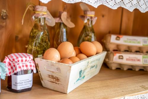 a box of eggs on a table with bottles at Wohnung Hallighof in Honkenswarft