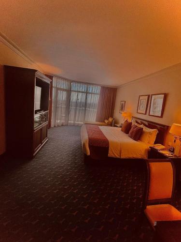 a hotel room with a bed and a television at Abha Palace Hotel in Abha