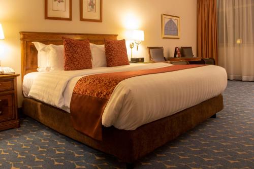 a bedroom with a large bed in a hotel room at Abha Palace Hotel in Abha
