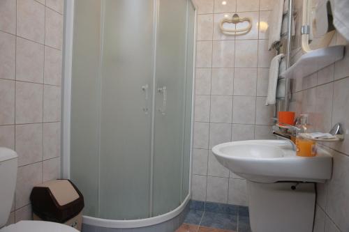 a bathroom with a shower and a sink at Guest House Linas in Alytus