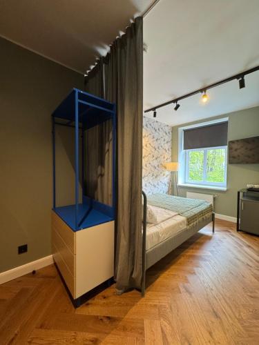 a bedroom with a bed with a blue shelf at Avitar in Rīga