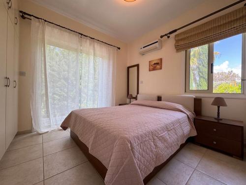 a bedroom with a bed and a large window at villa Maria in Neo Chorio