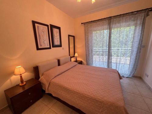 a bedroom with a bed and a large window at villa Maria in Neo Chorio